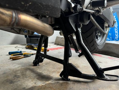Motorcycle on a stand with tools in the background