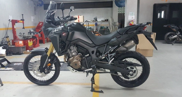 Motorcycle on a lift in a garage setting