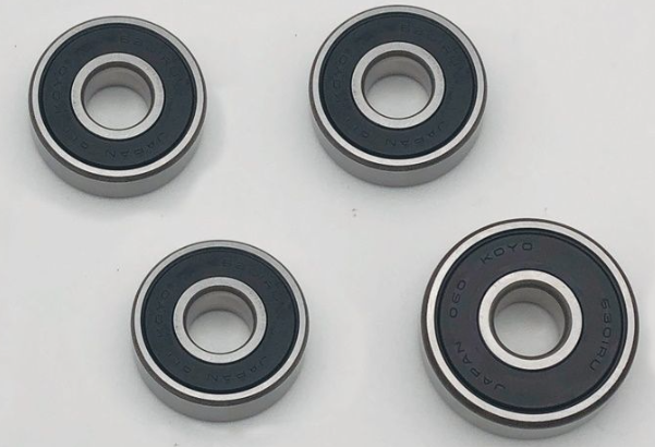 Four bearings with 'KOYO' branding on a white background