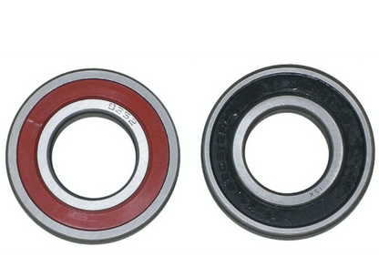 Two bearings, one red and silver, the other black and silver, on a white background.