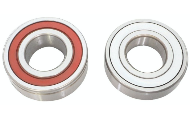 Two metal bearings with red rubber seals on a white background
