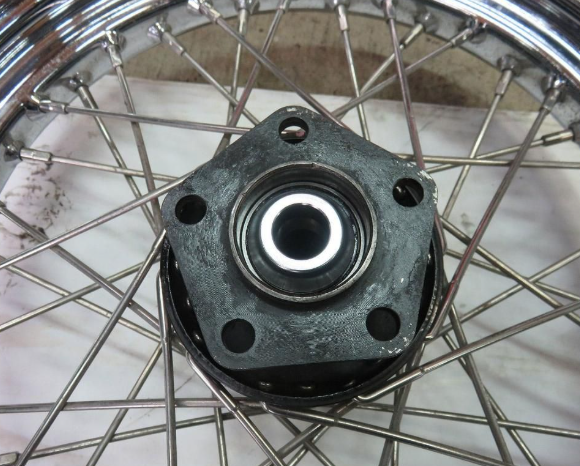 Close-up of a wheel hub with bearings on a metal rim