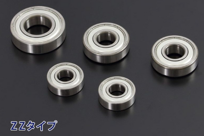 Set of five metal bearings on a dark background