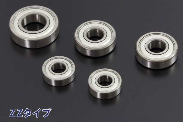 Set of five metal bearings on a dark background