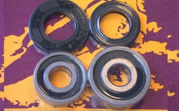 Four black bearings on a purple and yellow camouflage background