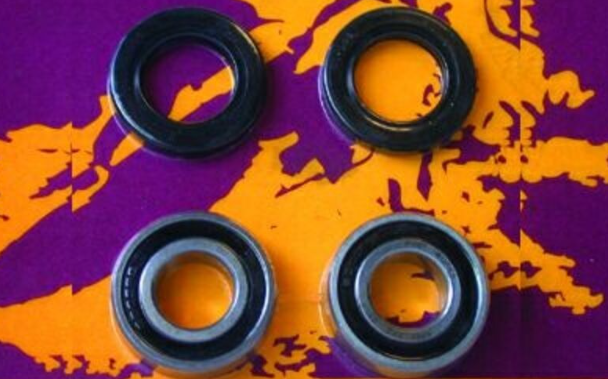 Four skateboard bearings on a purple and orange background