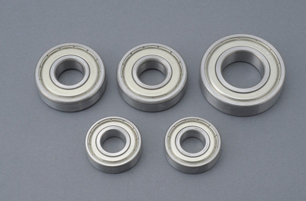 Five metal bearings on a gray background