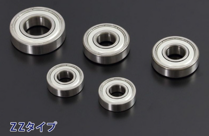 Five metal bearings on a black background