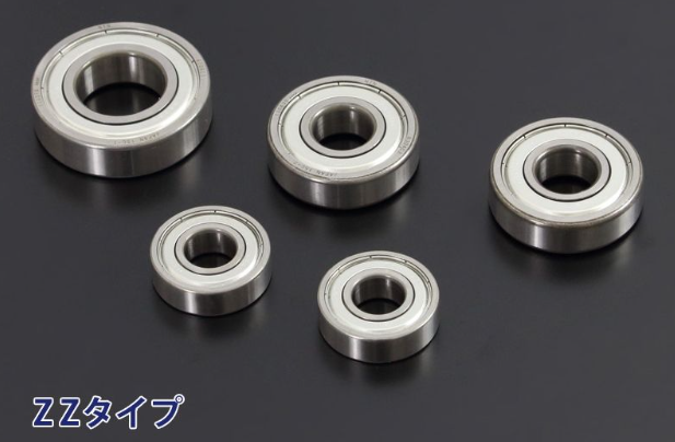 Five metal bearings on a black background
