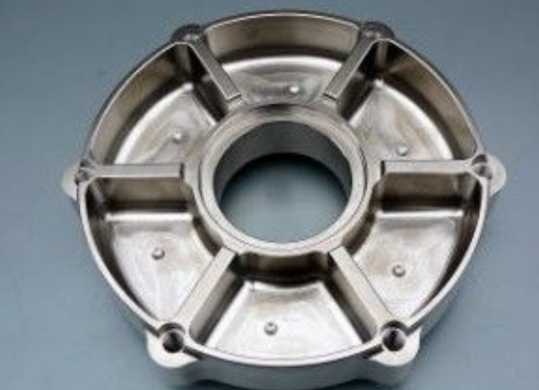 Metallic mechanical component on a gray background