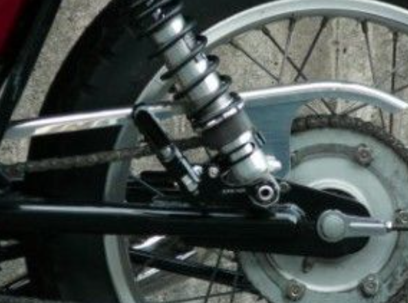 Close-up of a motorcycle suspension system with a blurred background