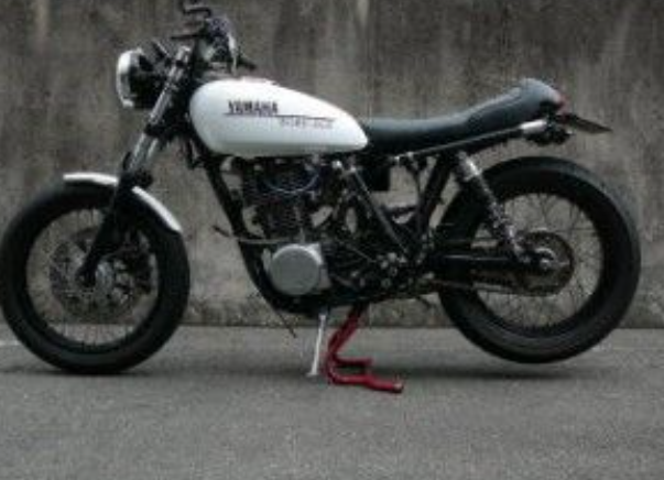 Yamaha motorcycle on a road with a concrete wall in the background