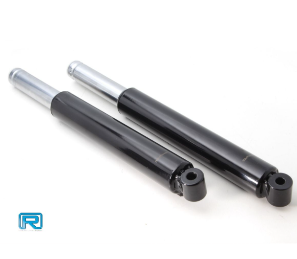 Two black shock absorbers with silver top ends on a white background