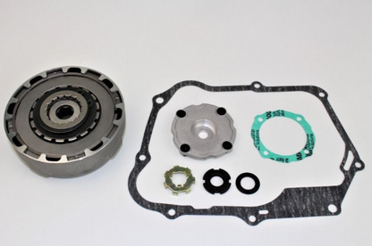 Mechanical parts including a clutch plate, gaskets, and washers on a white background