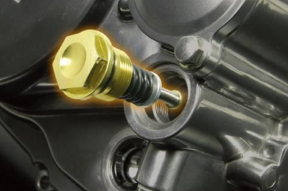 Close-up of a gold oil dipstick in a engine compartment