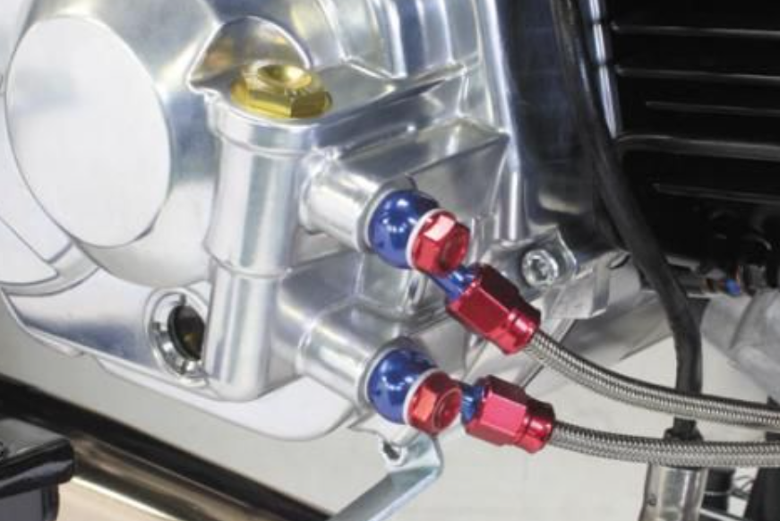 Close-up of a mechanical component with red and blue connectors on a vehicle.