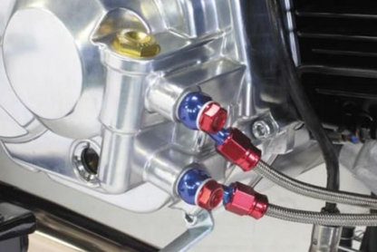 Close-up of a mechanical component with red and blue connectors on a vehicle.