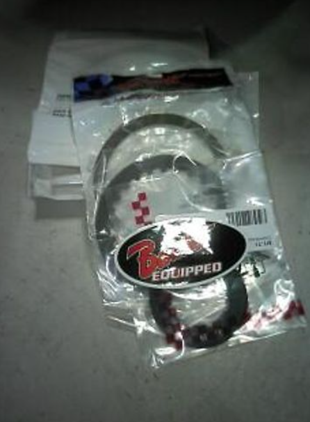 Two motorcycle exhaust gaskets in packaging with a brand logo on a gray surface.
