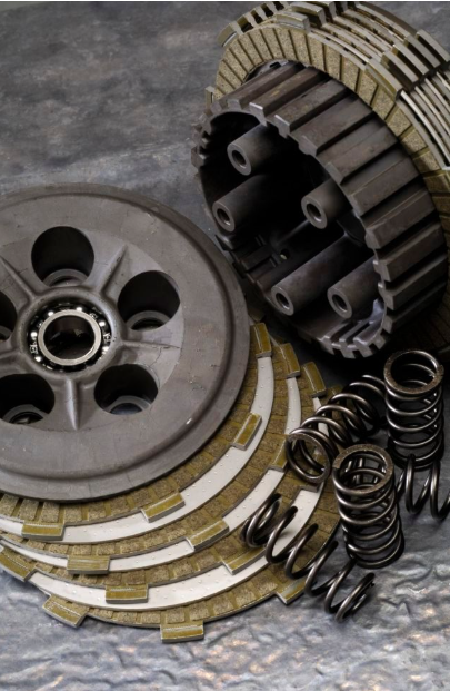 Clutch plates, springs, and pressure plate on a gray background