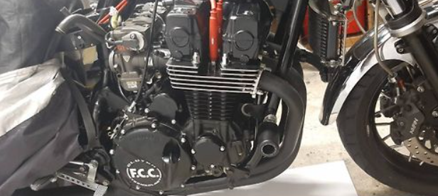 Close-up of a motorcycle engine with 'F.R.C.' branding.