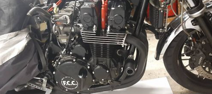 Close-up of a motorcycle engine with 'F.R.C.' branding.