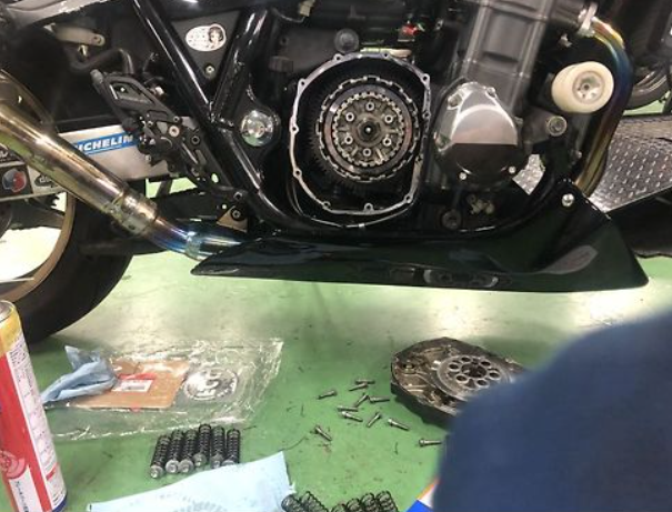 Motorcycle engine on a workbench with tools and parts