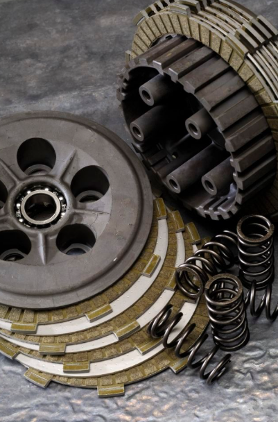Clutch plates, springs, and pressure plate on a gray background