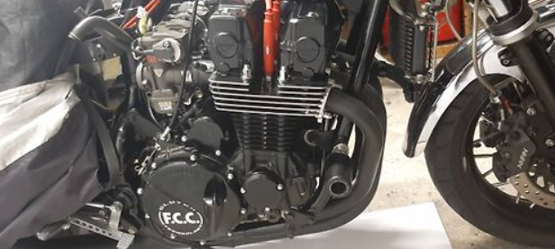 Close-up of a motorcycle engine with 'F.C.C.' branding.