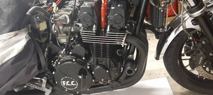 Close-up of a motorcycle engine with 'F.C.C.' branding.