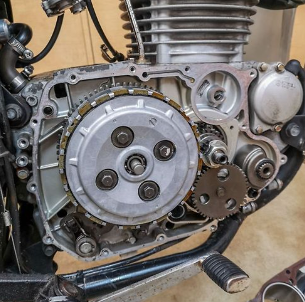 Close-up of a mechanical engine with gears and metal components.