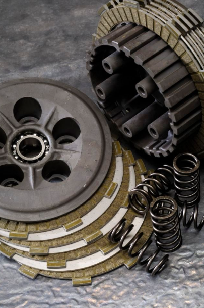 Clutch plates, springs, and pressure plate on a gray background