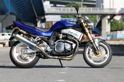 Blue Suzuki motorcycle on a road with a blurred background
