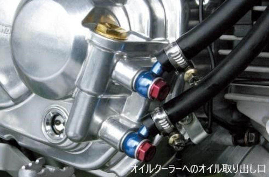 Close-up of a mechanical engine component with hoses and connectors.