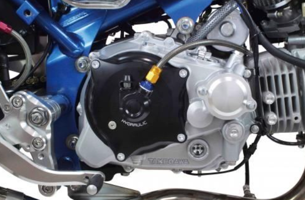 Close-up of a motorcycle engine with visible branding on a white background