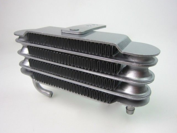 Metallic heat exchanger on a white background