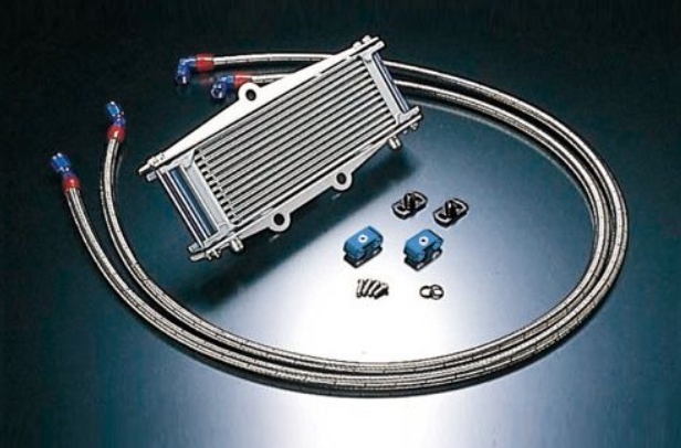 Oil cooler kit with hoses and connectors on a reflective surface