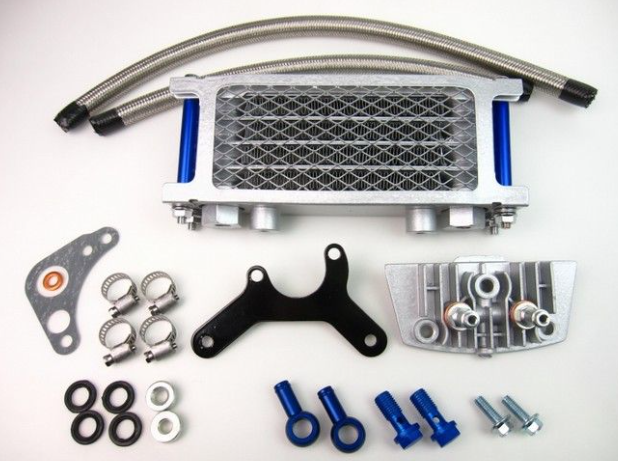 Mechanical parts including a metal radiator, hoses, and various fasteners on a white background