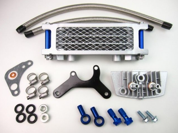 Collection of mechanical parts including a metal bracket, bolts, and gaskets on a white background