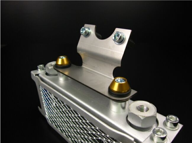 Metallic radiator with bolts on a black background