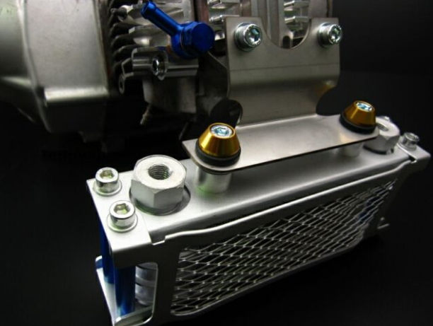 Close-up of a metallic engine component with bolts on a dark background