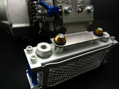 Close-up of a metallic engine component with bolts on a dark background