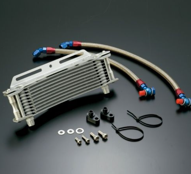 Oil cooler with hoses and mounting hardware on a dark background