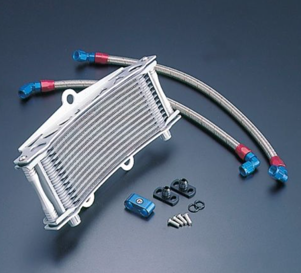 Oil cooler with hoses and connectors on a dark background