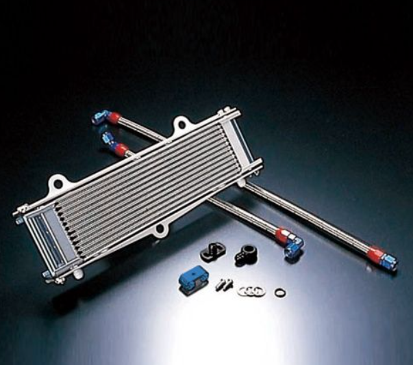 Metallic oil cooler with connectors and washers on a dark background