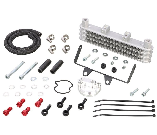 Collection of automotive parts including an oil cooler, gaskets, and bolts on a white background