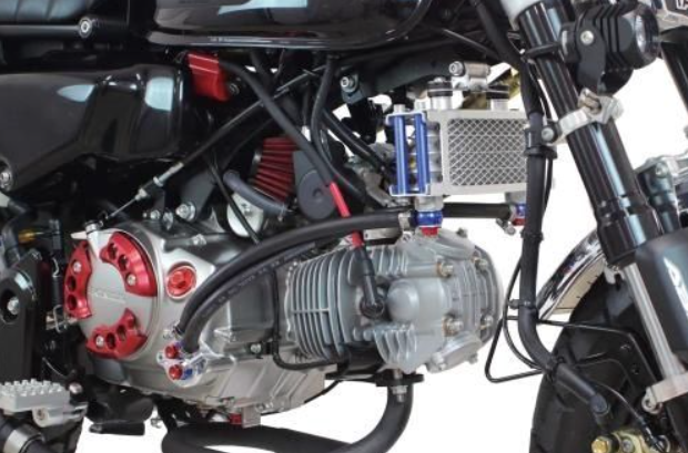 Close-up of a motorcycle engine with visible components on a white background