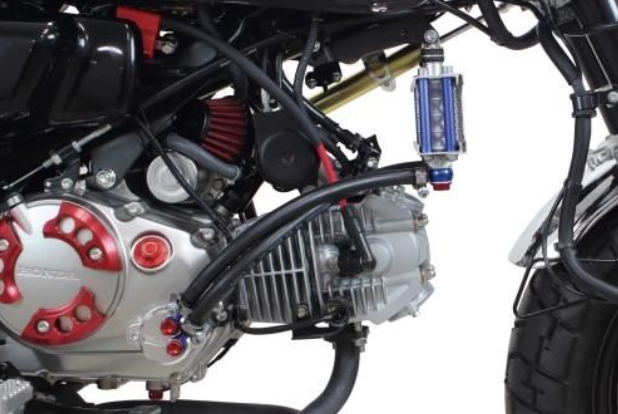 Close-up of a motorcycle engine with visible branding on a white background