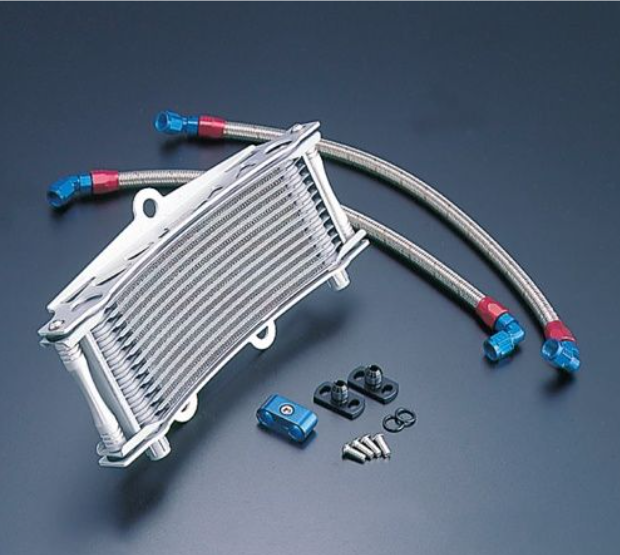 Oil cooler with hoses and connectors on a dark background