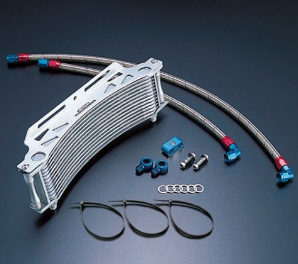 Oil cooler with hoses and fittings on a dark background