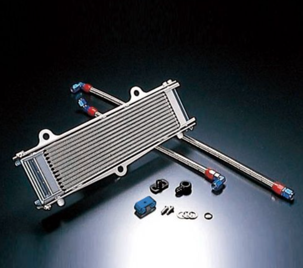 Metallic oil cooler with connectors on a dark background